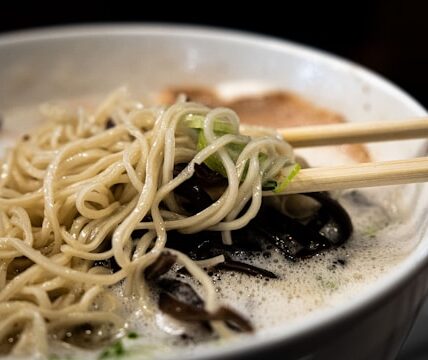 A steaming bowl of ramen being slurped at a Tokyo noodle shop