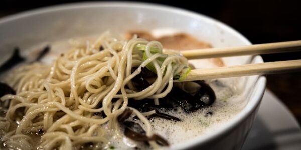 A steaming bowl of ramen being slurped at a Tokyo noodle shop